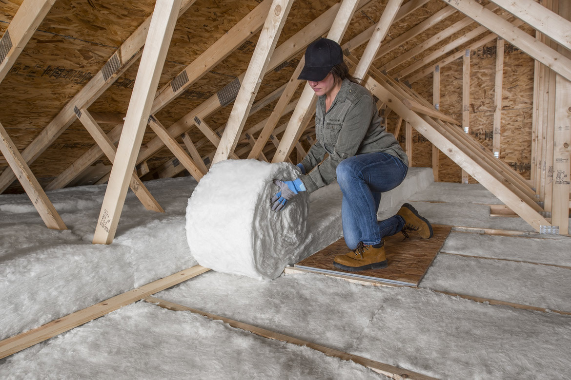 A Lady With Hat Doing Attic Installation