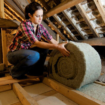 A Women Expert Rolling and Installing Attic