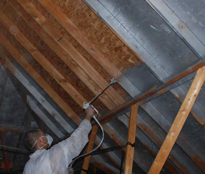 Radiant Barrier Installing By a Man